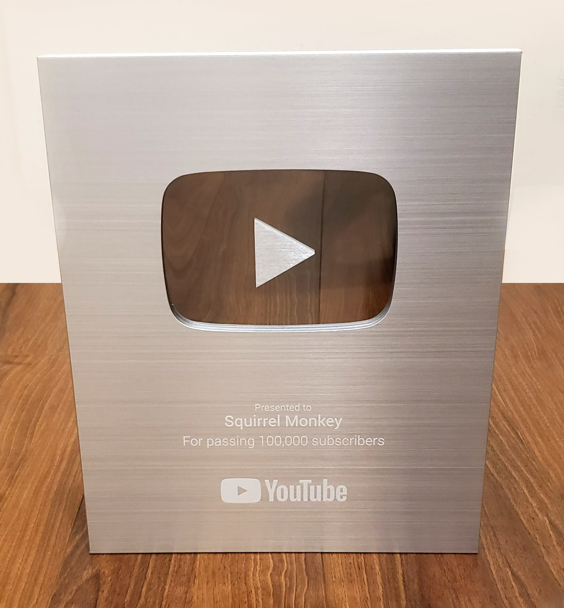 A YouTube creator award displayed on a desk.