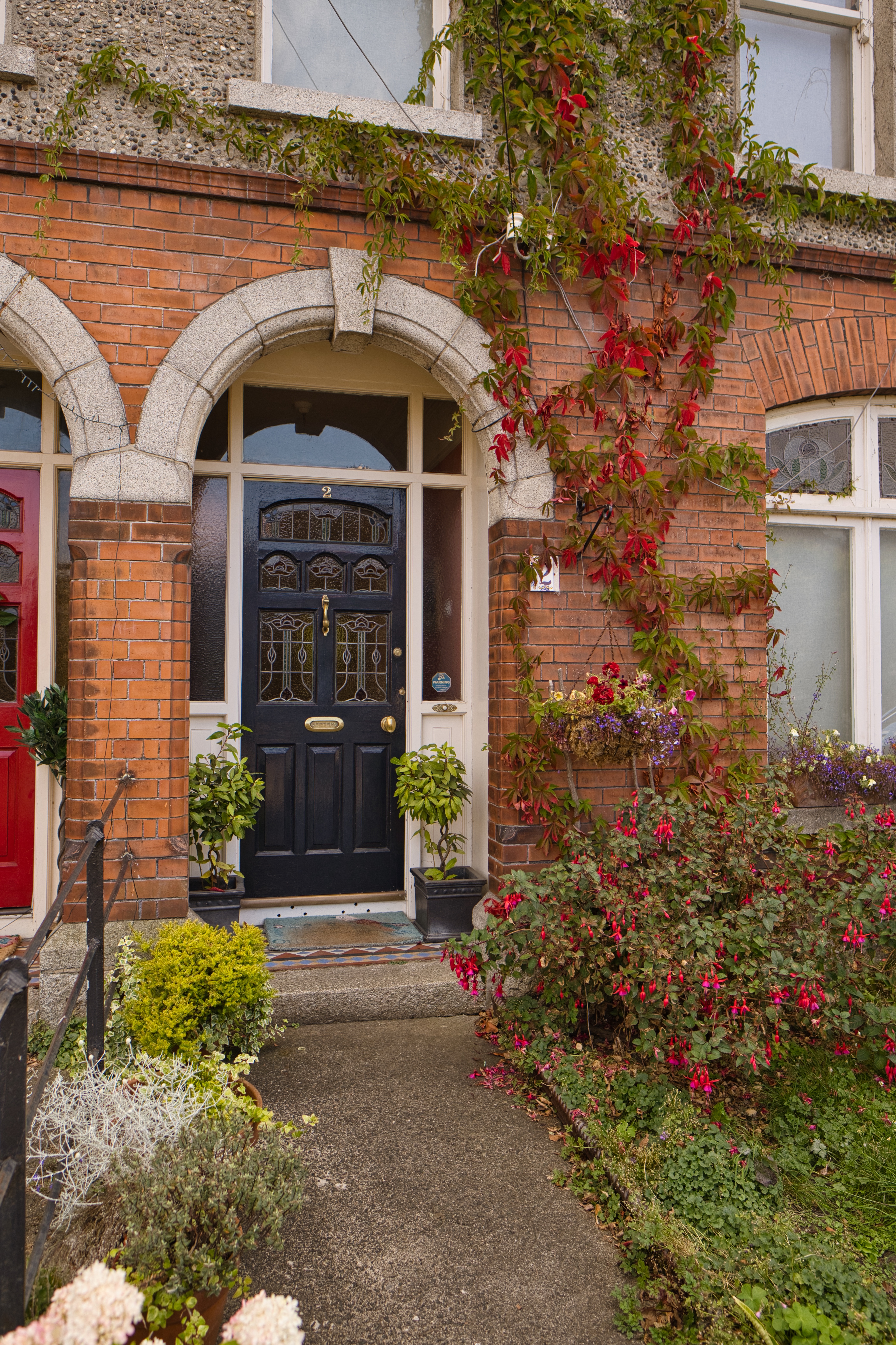 Front door with flowers and a clean entryway that create strong curb appeal
